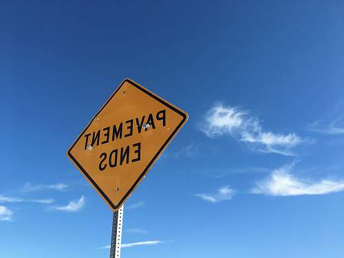 symbol yellow pavement ends road sign under blue sky 14918 chicago st