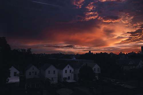 sunrise aerial photography of houses during golden hour sunset