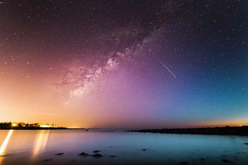 night milky way above body of water star