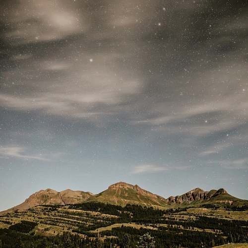 mountain mountains under cloudy blue sky landscape