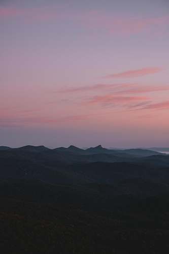 sunset silhouette of mountains under pink sky sunrise