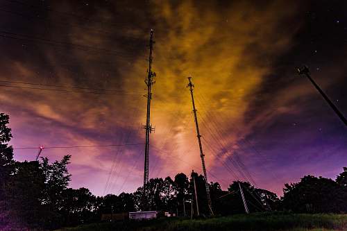 dawn two brown utility poles during golden hour dusk