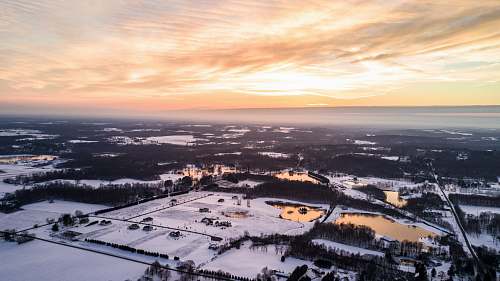 winter aerial photography of snow covered area under white cloudy skies golden hour photography mantua