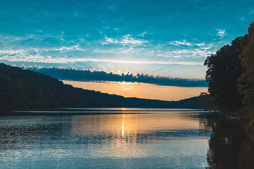 sunset body of water near mountain lake