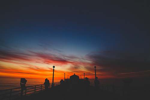 sunrise silhouette of wooden docks during golden hour sky