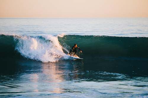ocean man surfing on ocean wave during daytime sea