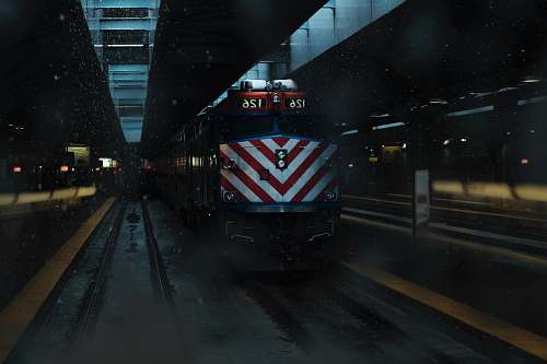 vehicle yellow and black train on rail track train station