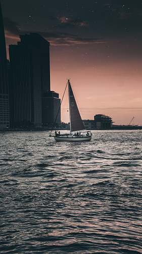 vessel black and gray sailboat on body of water watercraft