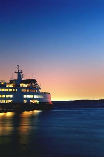 ferry lighted cruiseship on sea taken during golden hour boat