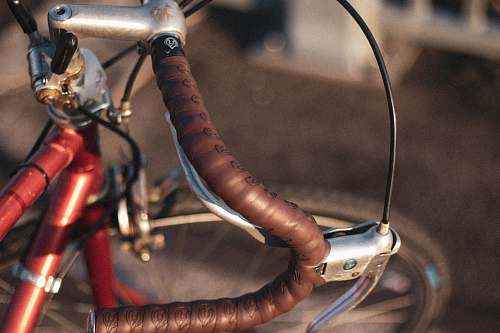 bike macro photography of red commuter bike handlebar bicycle