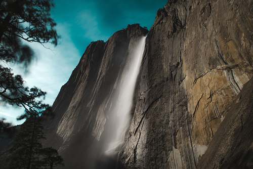 mountain low angle photo of waterfalls outdoors