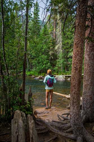 human woman standing in front of river person