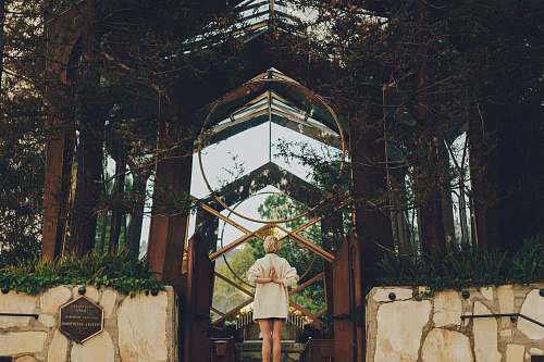 yoga woman standing near green leafed plants building