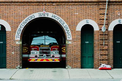 vehicle red firetruck under building door