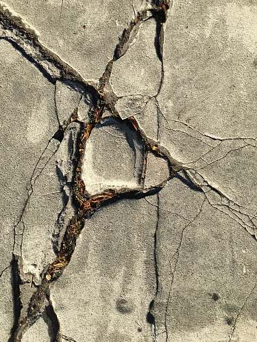 sidewalk close-up photo of broken concrete wall pavement