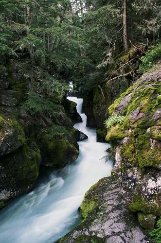 outdoors time-lapse photography of stream between rocks stream