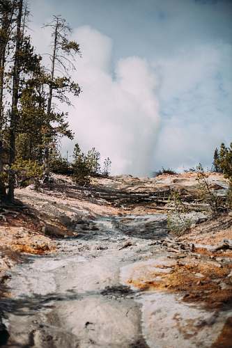 nature white clouds over steep rock slope outdoors