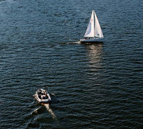 boat two white motorboats floating on water at daytime yacht