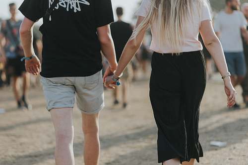 clothing couple holding hands while walking shorts