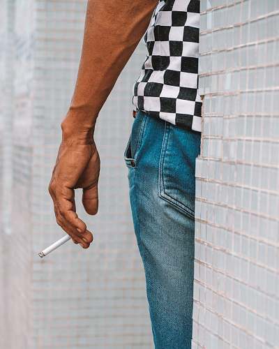 clothing perso nwearing blue faded jeans pants