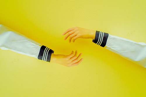 clothing two hands reaching each other on yellow background arm