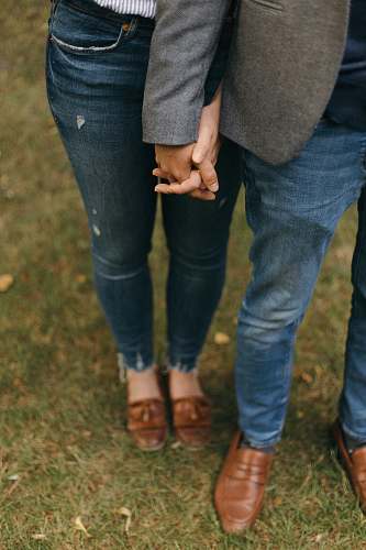 clothing two person standing while holding hands together pants