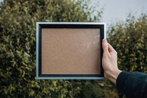 frame person holding rectangular white and black frame blank frame
