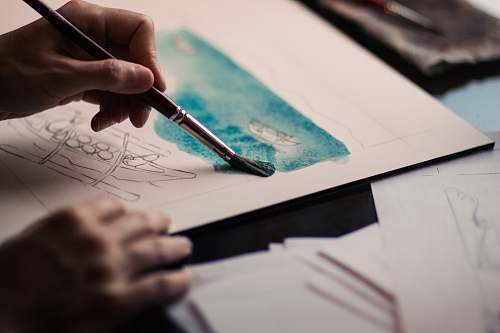 creative person holding paint brush artist