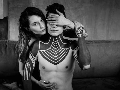 skin grayscale photography of man and woman tattoo