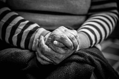 hands grayscale photography of sitting person colombia