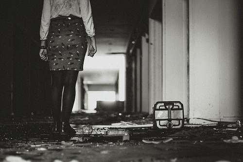 grey woman wearing skirt beside white building girl