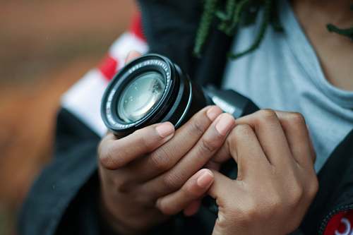 dslr person holding black DSLR camera photographer