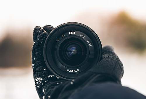 electronics person holding Rokinon zoom lens camera lens