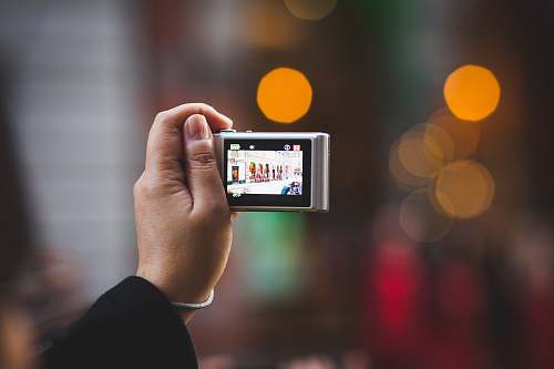 finger person holding digital camera using camera