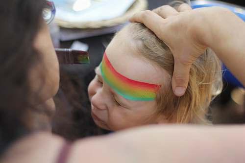 rainbow woman stroking child's hair childhood