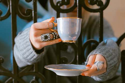 tea person holding teacup and saucer ring