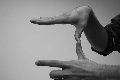 black-and-white human hands forming a U grey
