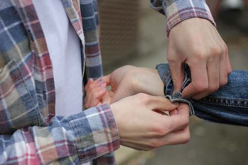 accessory person fixing man's jacket tie