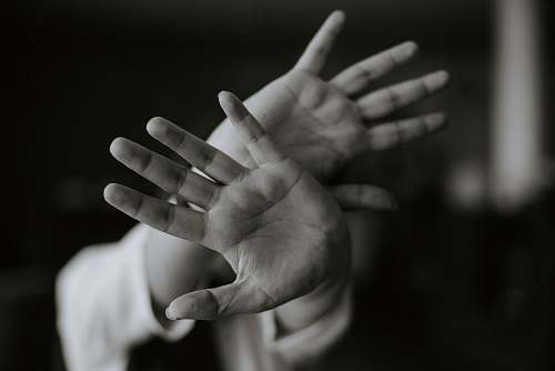 grey person stretching their hands libya