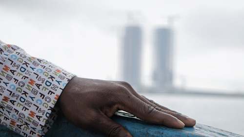 hand person wearing white long-sleeved top grey