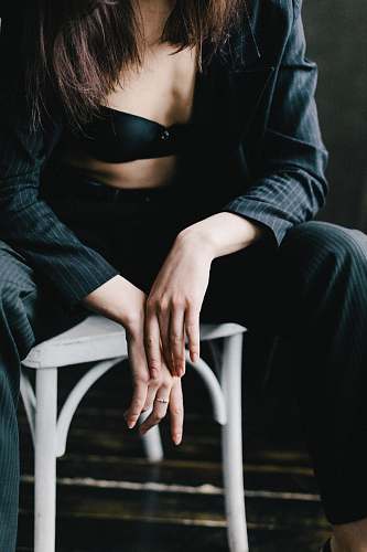 person woman sitting on white wooden chair human