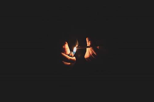 fire person lighting cigarette lighter