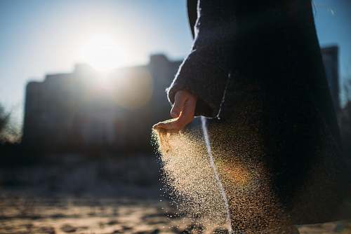 light person holding brown sand apparel