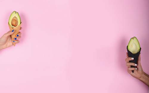 pink person holding avocado background