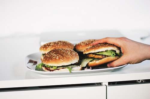 burger person holding hamburger on plate bread