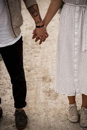 clothing man and woman standing and holding hands together apparel