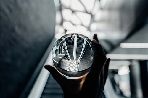 glass person holding clear glass decor ball