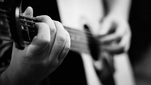 black-and-white person playing guitar guitar