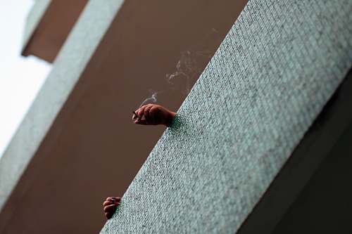 person bottom view of person smoking balcony