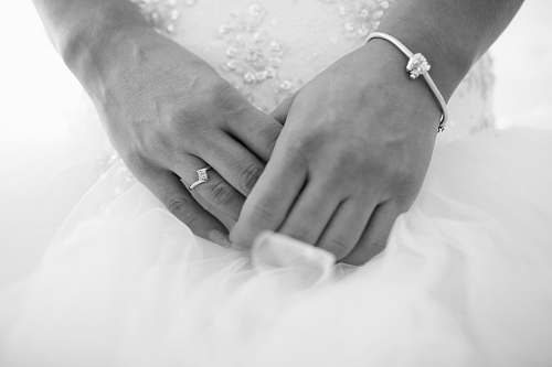 black-and-white bride and groom holding hands grey